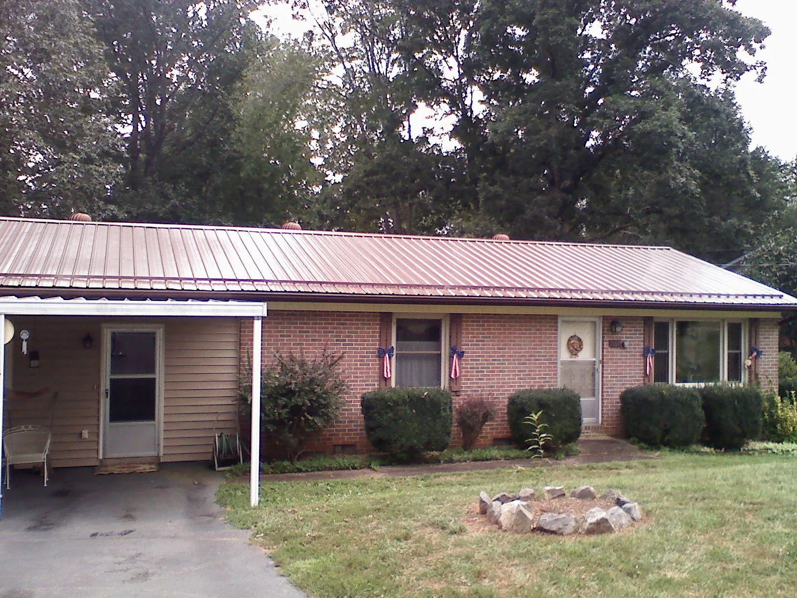 Bronze metal roof and carport on a brick ranch home — Roof Repair work by our crew in Milpitas